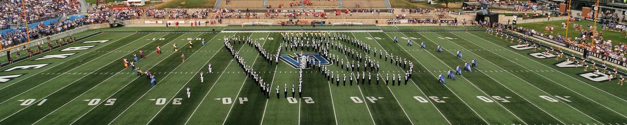 The Laker Marching Band forming the interlocking GV logo on the field of Lubbers Stadium